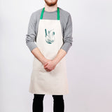 Apron with fennel screen print, designed by Curious Lions and made in the UK. This unisex natural cotton item makes a rustic gift.
